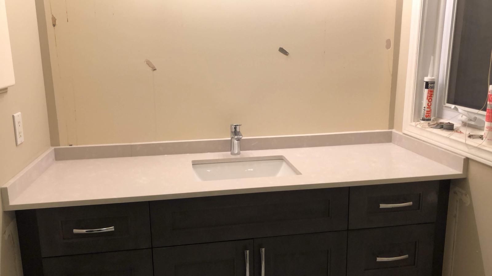 Light stone vanity top with an undermount sink